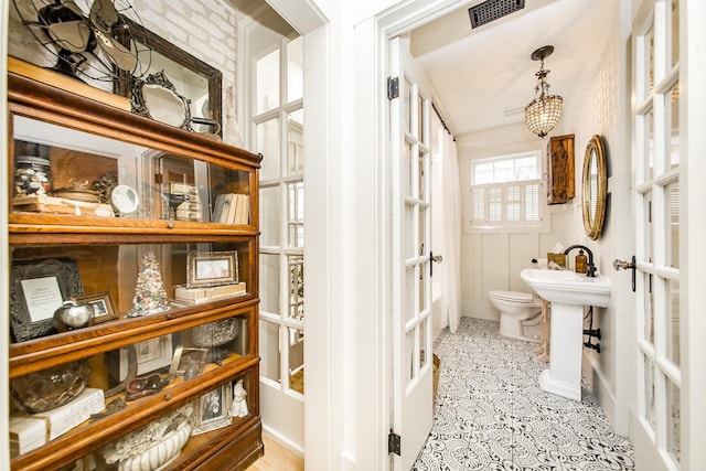 bathroom featuring sink, tile patterned floors, and toilet