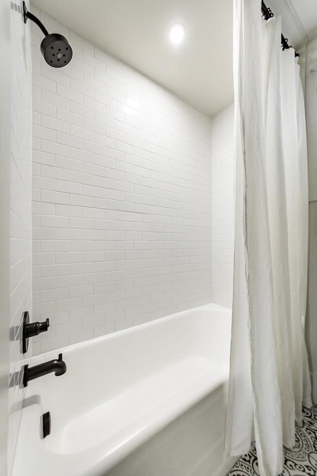 bathroom with shower / bath combo with shower curtain