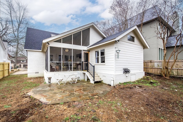 back of property featuring a sunroom and a patio area