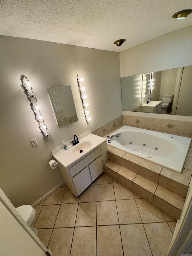 bathroom with tile patterned floors, toilet, a textured ceiling, and vanity