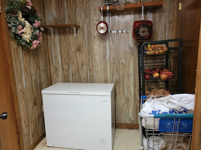 laundry area with wood walls