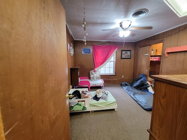 bedroom with crown molding, ceiling fan, and carpet flooring