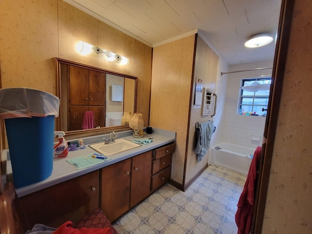 bathroom with vanity, tiled shower / bath combo, heating unit, and ornamental molding