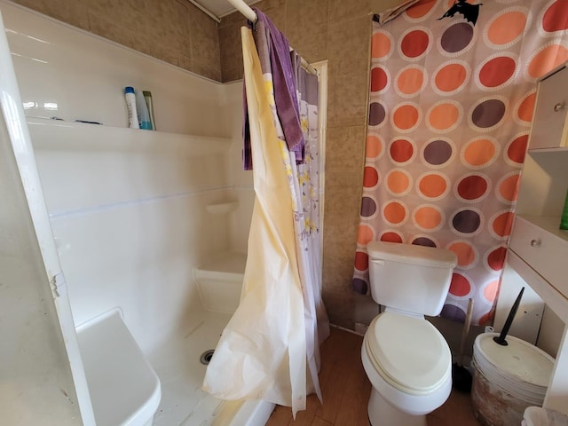 bathroom featuring toilet and walk in shower