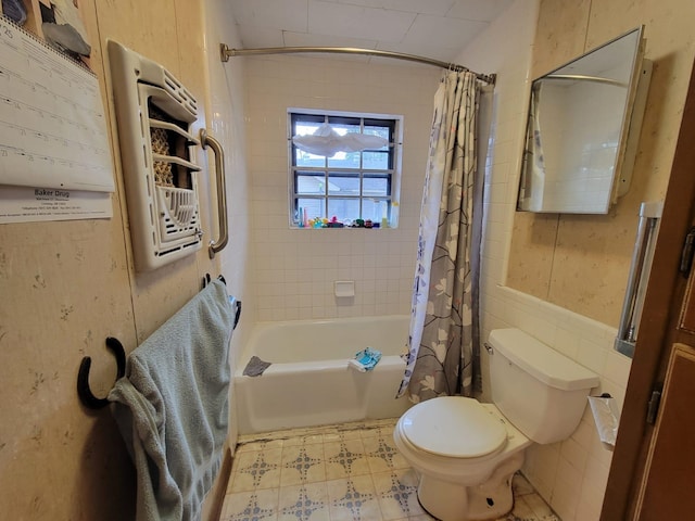 bathroom featuring shower / tub combo, tile walls, and toilet