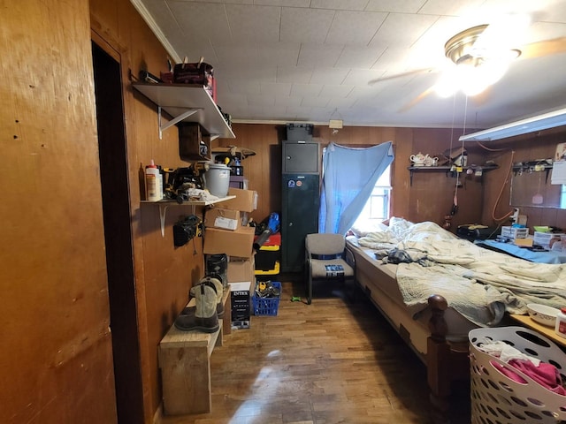 interior space with hardwood / wood-style floors and wooden walls