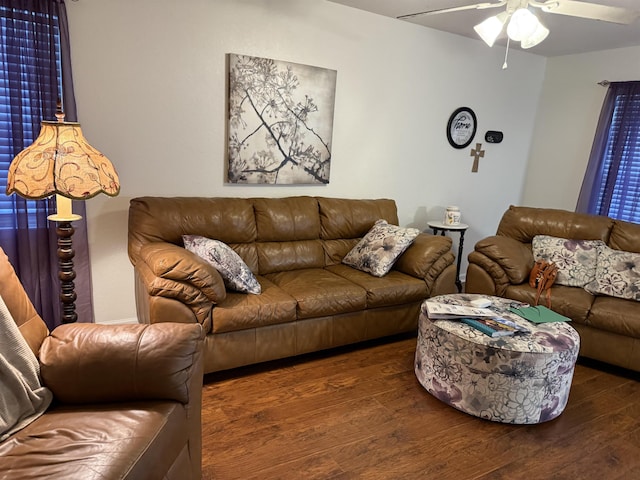 living room featuring ceiling fan and dark hardwood / wood-style flooring