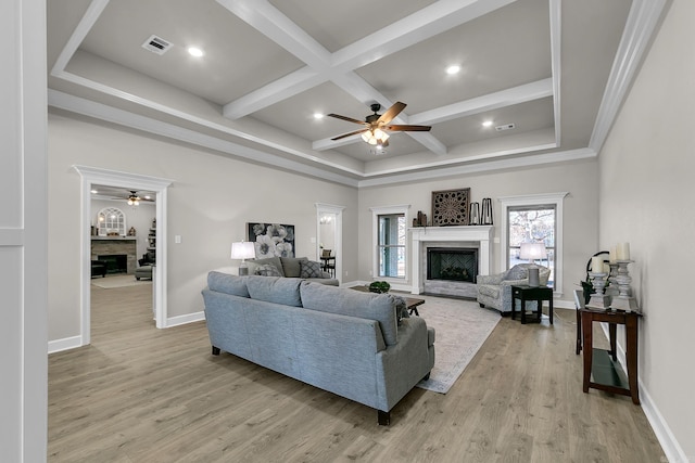 living room with coffered ceiling, light hardwood / wood-style flooring, beamed ceiling, and ceiling fan