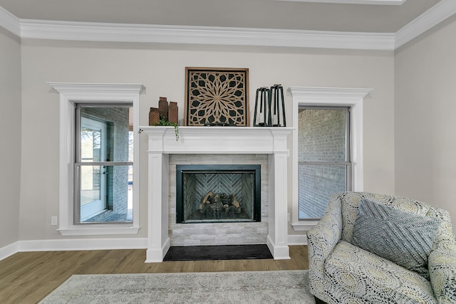 sitting room with crown molding and wood-type flooring