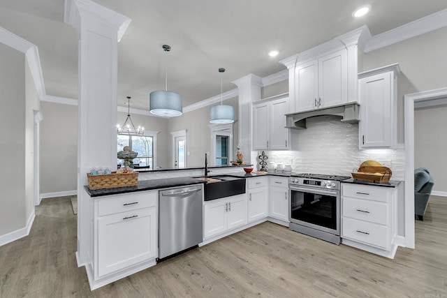 kitchen with pendant lighting, sink, stainless steel appliances, and white cabinets