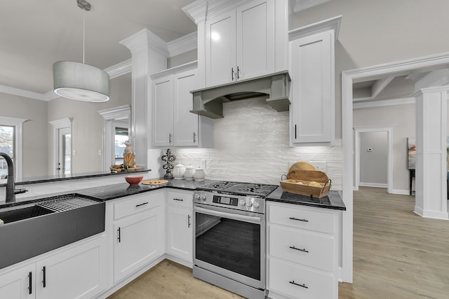 kitchen with pendant lighting, stainless steel range with gas stovetop, ornamental molding, custom range hood, and white cabinets