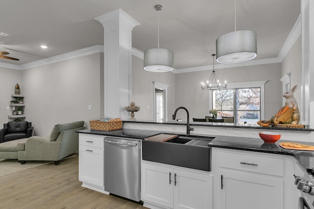 kitchen with sink, hanging light fixtures, dark stone countertops, dishwasher, and white cabinets