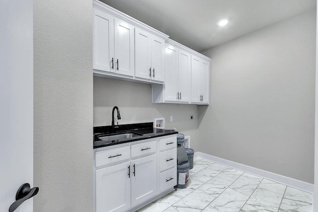 laundry room with cabinets, hookup for a washing machine, sink, and electric dryer hookup