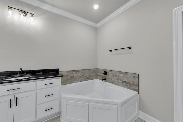 bathroom with vanity, ornamental molding, and a tub