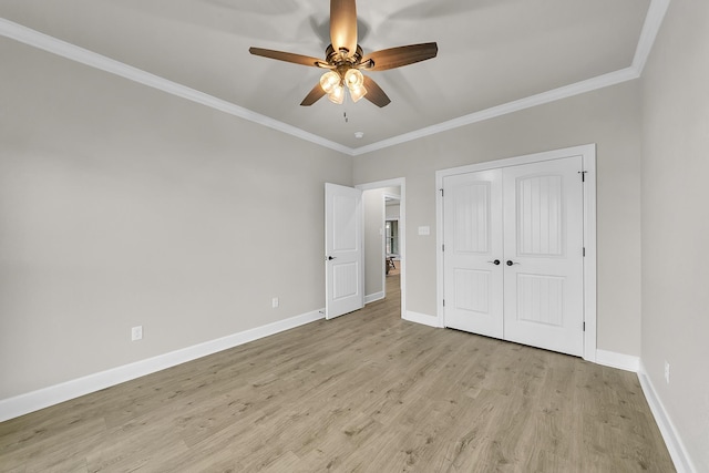 unfurnished bedroom featuring ceiling fan, a closet, ornamental molding, and light hardwood / wood-style flooring