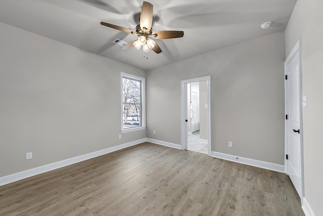 spare room featuring light hardwood / wood-style floors and ceiling fan