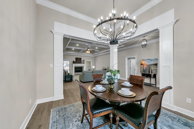 dining area featuring ceiling fan, hardwood / wood-style floors, coffered ceiling, ornamental molding, and beamed ceiling