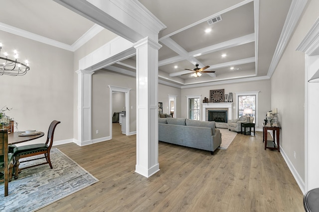 living room with coffered ceiling, decorative columns, hardwood / wood-style flooring, beamed ceiling, and ceiling fan with notable chandelier