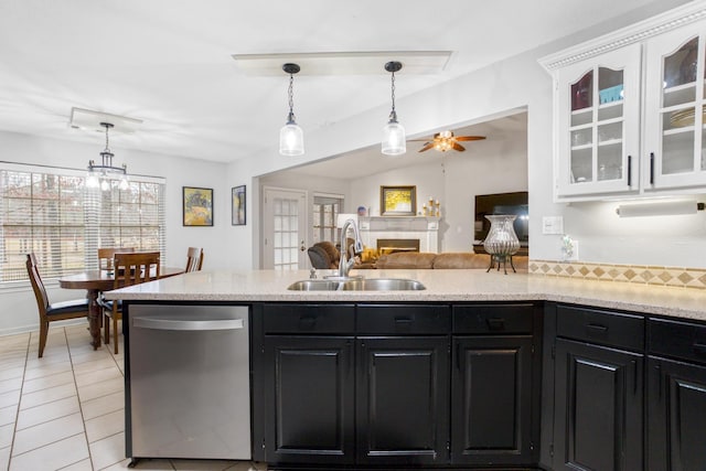 kitchen featuring light tile patterned flooring, pendant lighting, dishwasher, sink, and white cabinets