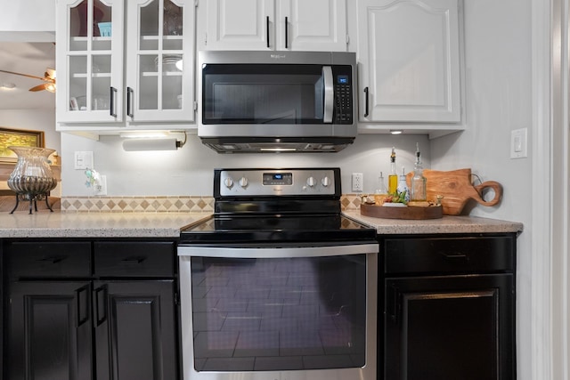 kitchen with ceiling fan, stainless steel appliances, and white cabinets