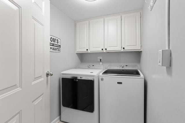 laundry area featuring cabinets and washer and clothes dryer