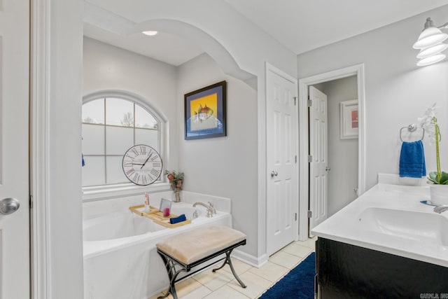 bathroom featuring tile patterned floors, vanity, and a bathing tub