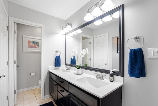 bathroom with vanity, tile patterned flooring, and toilet