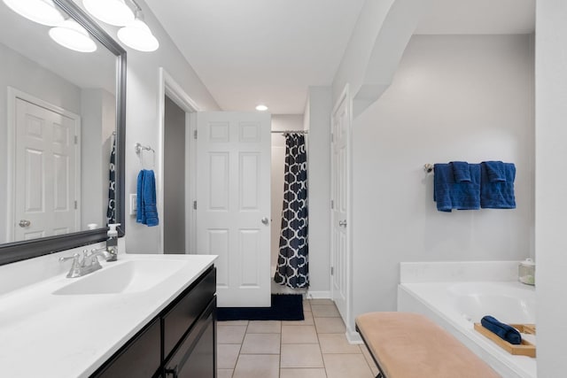 bathroom with vanity, tile patterned floors, and shower with separate bathtub