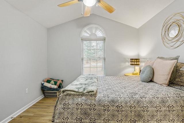 bedroom featuring ceiling fan, lofted ceiling, and light wood-type flooring