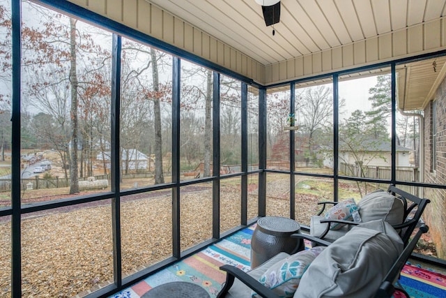 unfurnished sunroom with ceiling fan