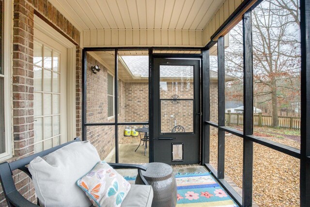 sunroom / solarium featuring wood ceiling