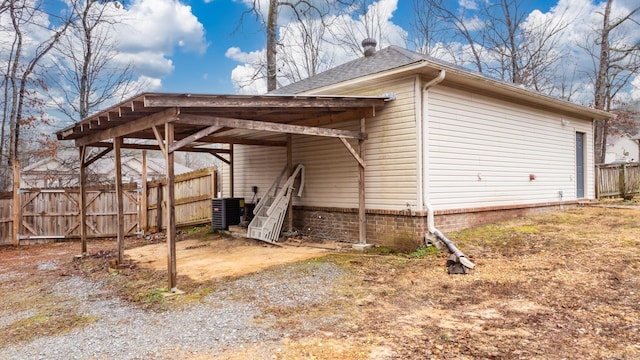 exterior space with a carport and central air condition unit