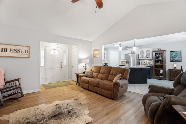 living room with ceiling fan, sink, high vaulted ceiling, and light hardwood / wood-style flooring