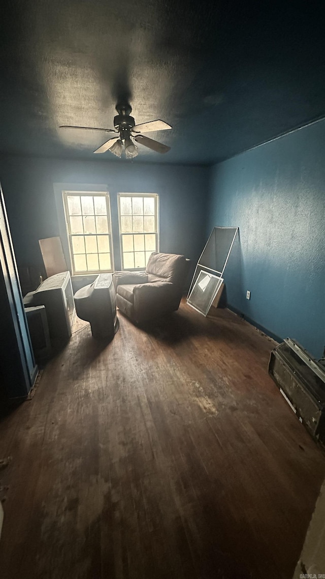 unfurnished bedroom with dark hardwood / wood-style flooring, a textured ceiling, and ceiling fan