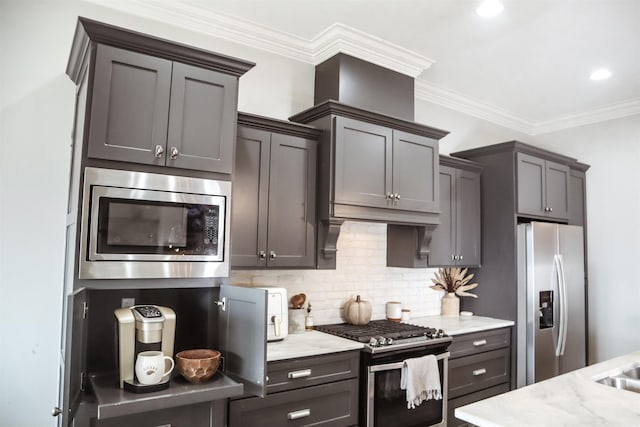 kitchen featuring tasteful backsplash, ornamental molding, appliances with stainless steel finishes, and light stone countertops