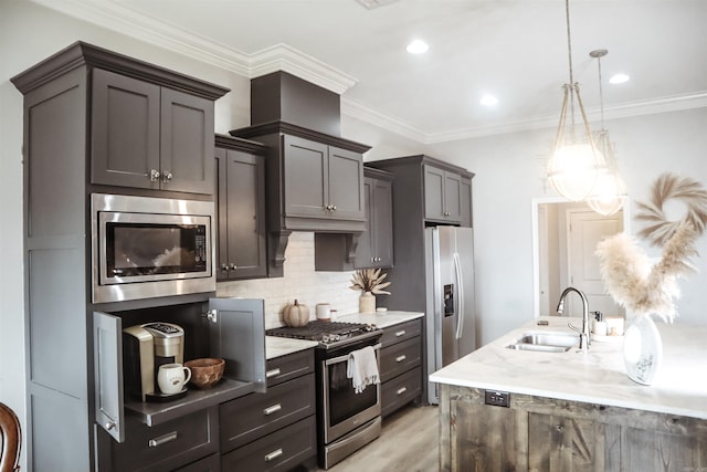 kitchen featuring appliances with stainless steel finishes, decorative light fixtures, sink, decorative backsplash, and crown molding