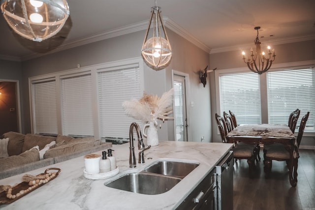 kitchen with light stone countertops, sink, pendant lighting, and dark wood-type flooring