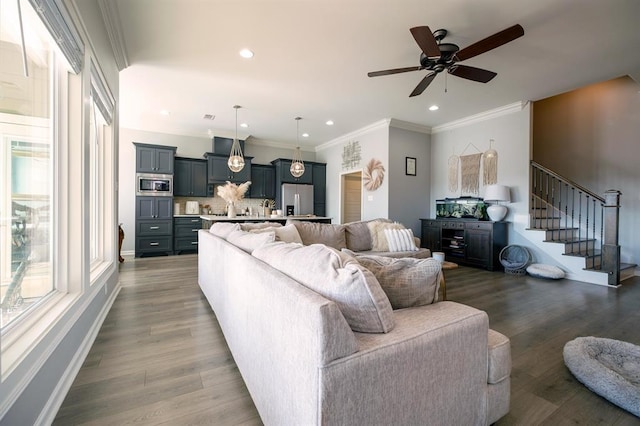 living room featuring crown molding, ceiling fan, and dark hardwood / wood-style flooring