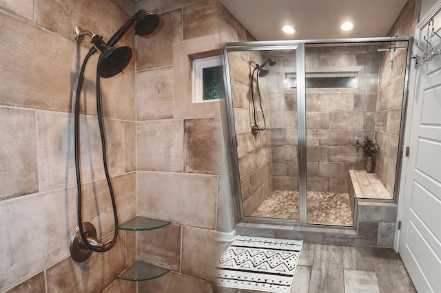 bathroom featuring a shower with door