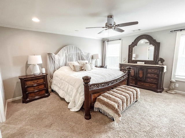 carpeted bedroom featuring ceiling fan, ornamental molding, and multiple windows