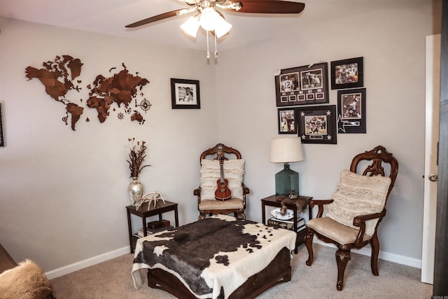 living area featuring carpet flooring and ceiling fan