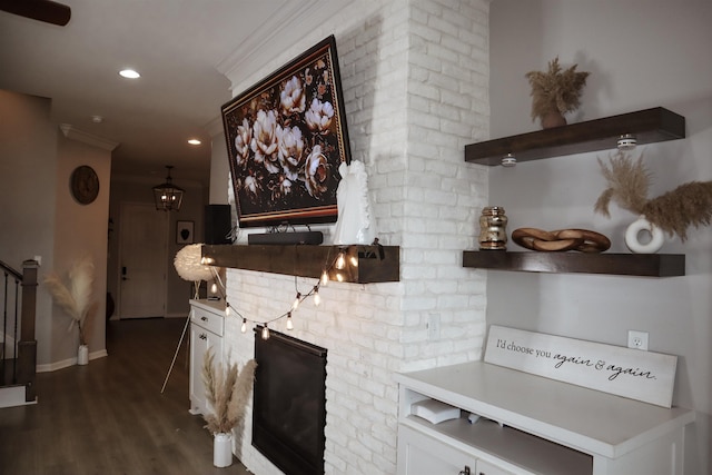 kitchen featuring crown molding, dark hardwood / wood-style flooring, and white cabinets