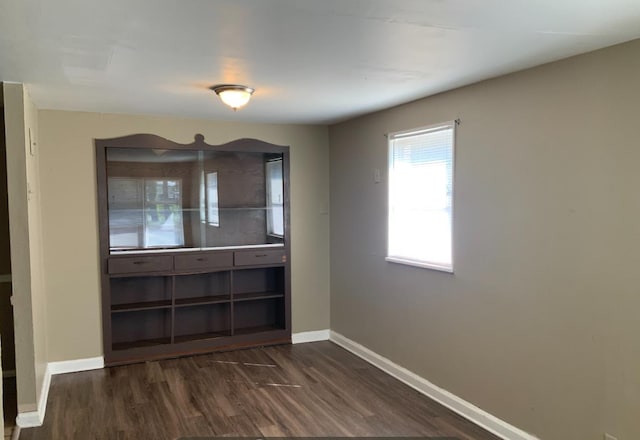 unfurnished dining area featuring dark hardwood / wood-style floors