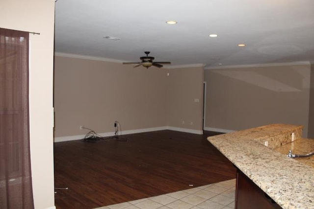 unfurnished living room featuring ornamental molding, light hardwood / wood-style floors, and ceiling fan