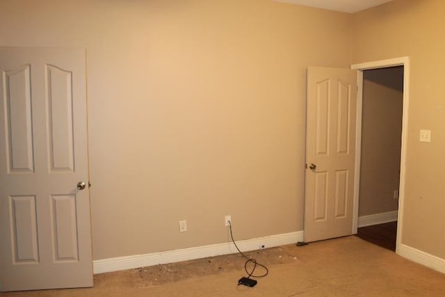 spare room featuring light colored carpet