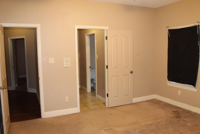 unfurnished bedroom featuring light carpet