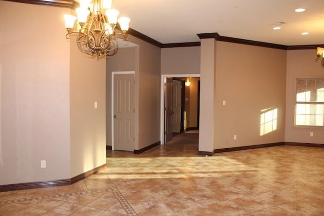 spare room with ornamental molding and a notable chandelier