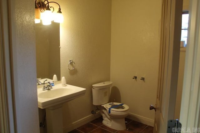 bathroom featuring tile patterned flooring and toilet