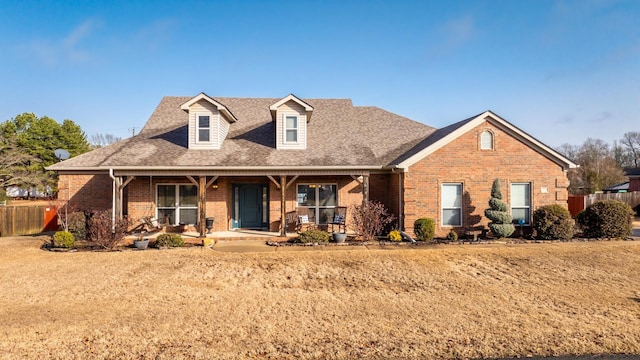 view of front of house featuring a porch and a front lawn