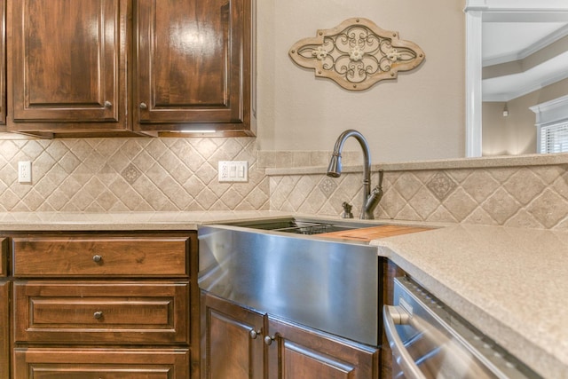 kitchen with crown molding, decorative backsplash, and dishwasher